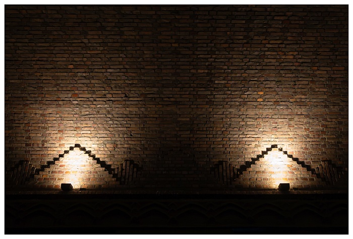 Blick auf die runde Mauer im Durchgang zum Chilehaus bei Nacht