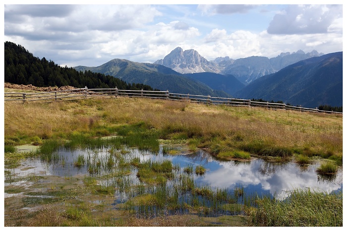 Mountain scenery of a small lake in Italy with beautiful clouds